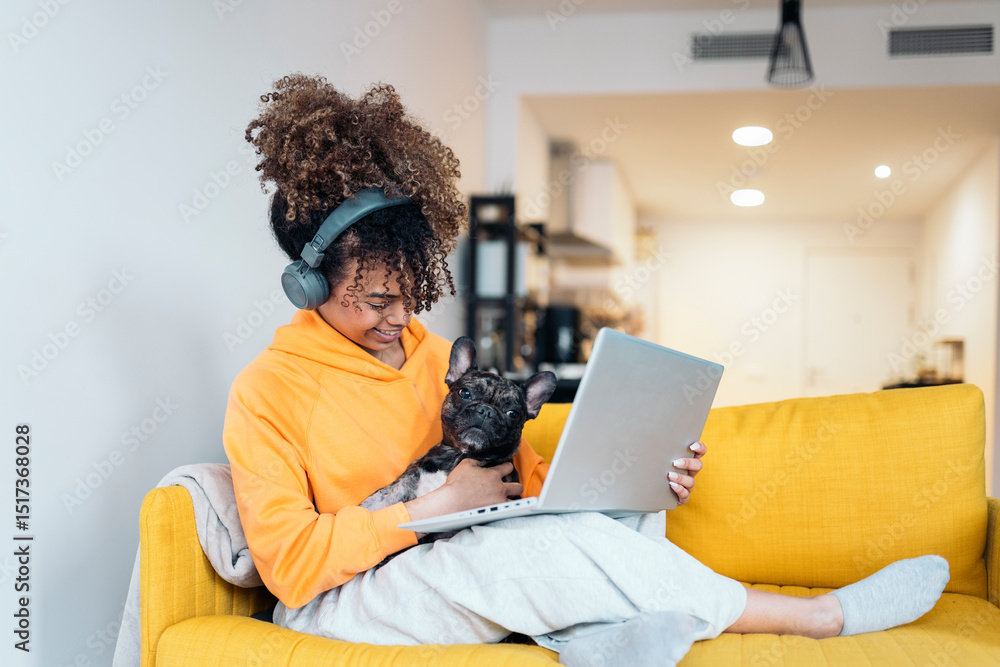 Freelancer working from home with her french bulldog on the sofa Freelancer working from home with her french bulldog on the sofa