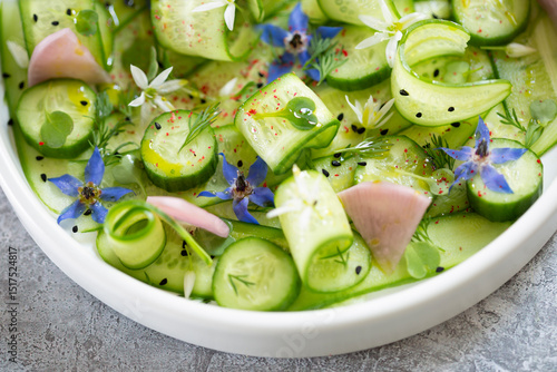 Fresh cucumber salad with spring flowers