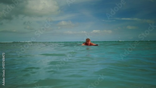 Old woman learns to surf. Senior female goes surfing with surfboard, beginner student. First lesson