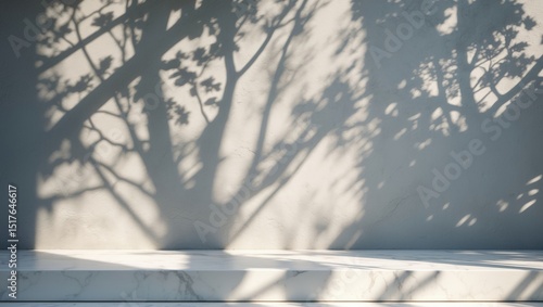 White marble table corner featuring tree shadow and bokeh effects on concrete wall background for product display and interior design
