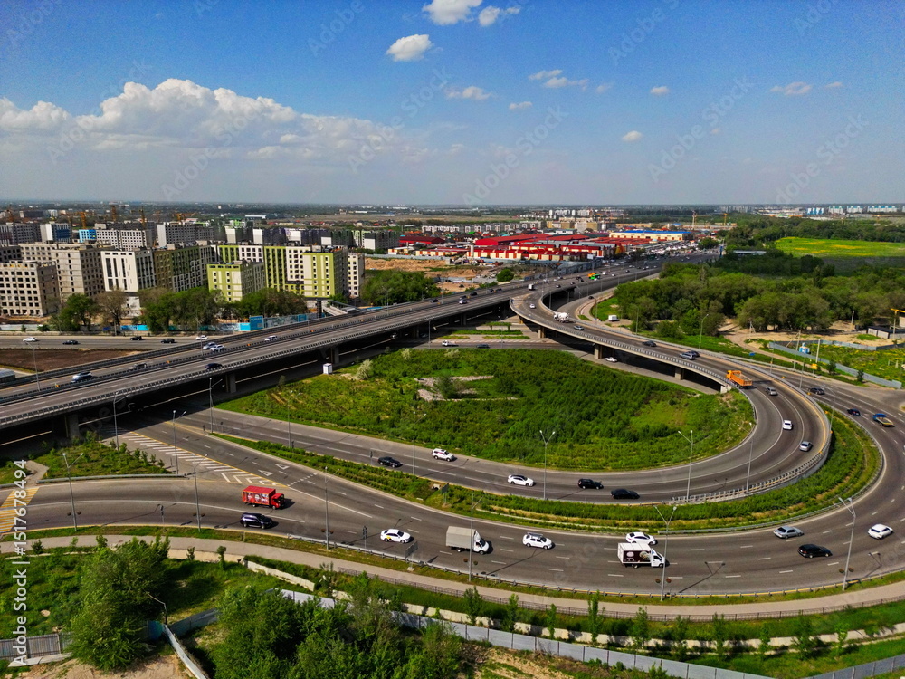 Fototapeta premium Various residential buildings and a transport interchange on the outskirts of the city. The view from the drone.
