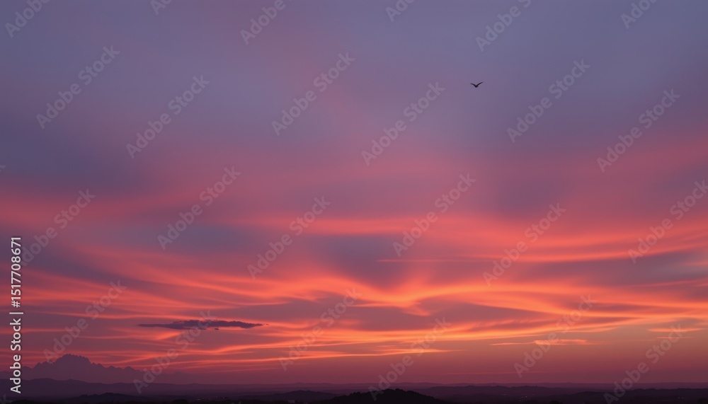 Fototapeta premium Serene Sunset Sky Vibrant Pink and Orange Hues over Distant Hills