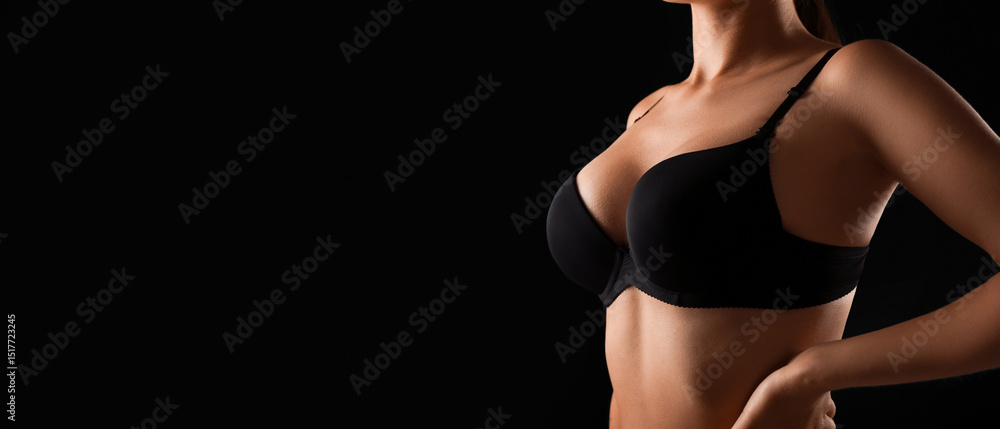 Naklejka premium Young woman in bra on black background, closeup