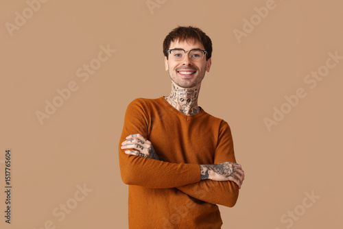 Happy young man on brown ba...