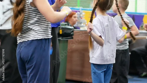 Adults and children are warming up at the entertainment sports center. The blue T-shirt says instructor in Russian