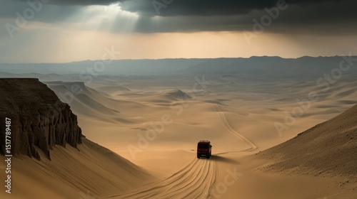 A lone vehicle travels across vast desert sand dunes under a dramatic, cloudy sky at sunset in a remote and arid landscape.
