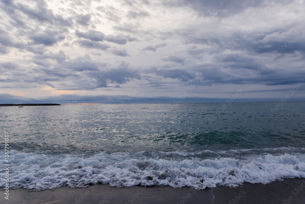 Sea surf waves on a sandy shore in overcast morning Sea surf waves on a sandy shore in overcast morning