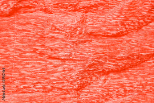 Texture of crumpled corrugate coral paper as background, closeup