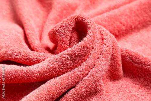 Texture of crumpled coral bath towel as background, closeup