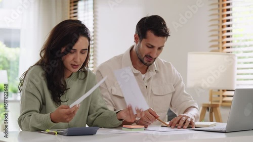 Couple overwhelmed by overdue bills and low income, facing economic stress and inflation-related financial crisis