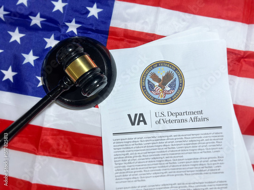 Veteran affairs and gavel with the American flag in the backdrop, top view.
