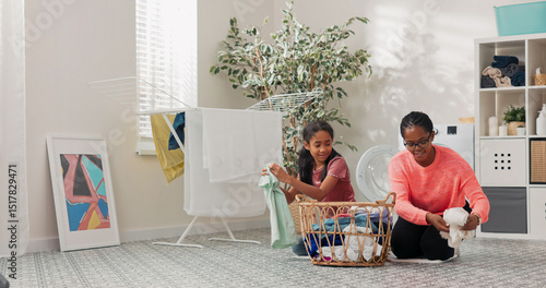 The daughter helps mother with household chores, the women sort laundry, fold clothes, prepare them for drying, they spend time together in the bathroom talking smiling