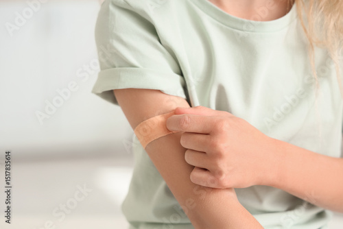 Child's arm with adhesive b...