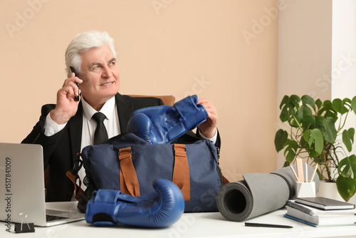 Senior businessman with box...