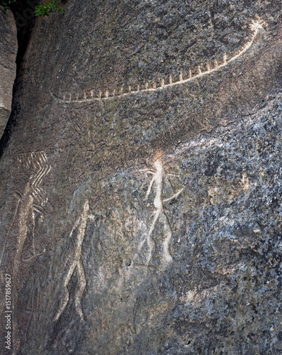Ancient rock paintings petroglyphs of people with a boat in Gobustan National Park. Baku, Azerbaijan.