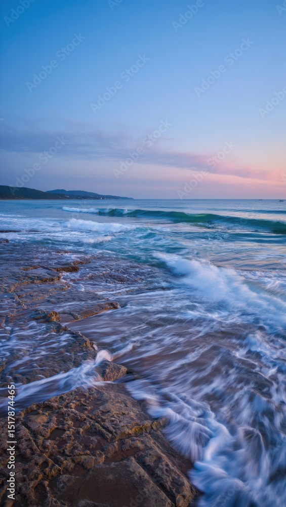 Obraz premium Serene coastal dawn waves crashing on rocks