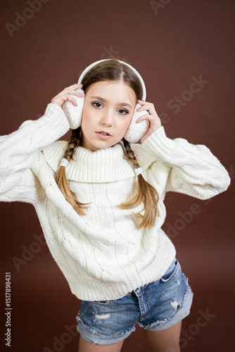 teenage girl in furry headphones model posing
