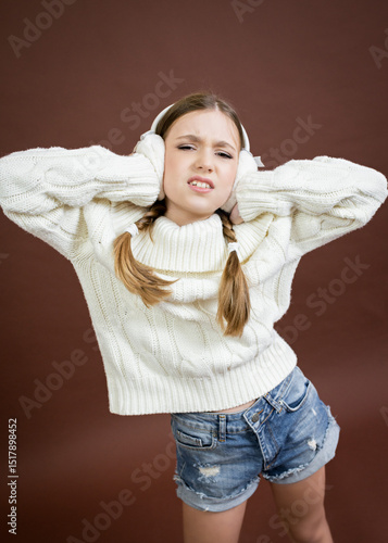 teenage girl in furry headphones model posing