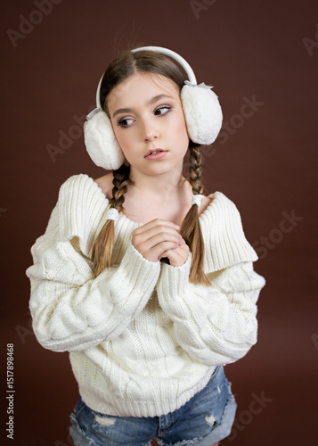 teenage girl in furry headphones model posing