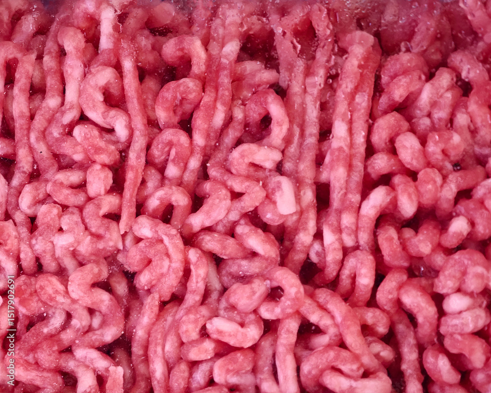 Obraz premium Freshly ground minced meat ready for cooking in a kitchen setting during the daytime