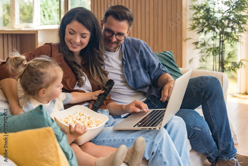 Bilde på lerret Happy young family with child enjoying new home after moving in – unpacking boxes, relaxing in living room, spending time together in kitchen, celebrating new beginning