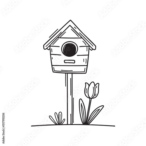 A tulip sprouting beneath a birdhouse post