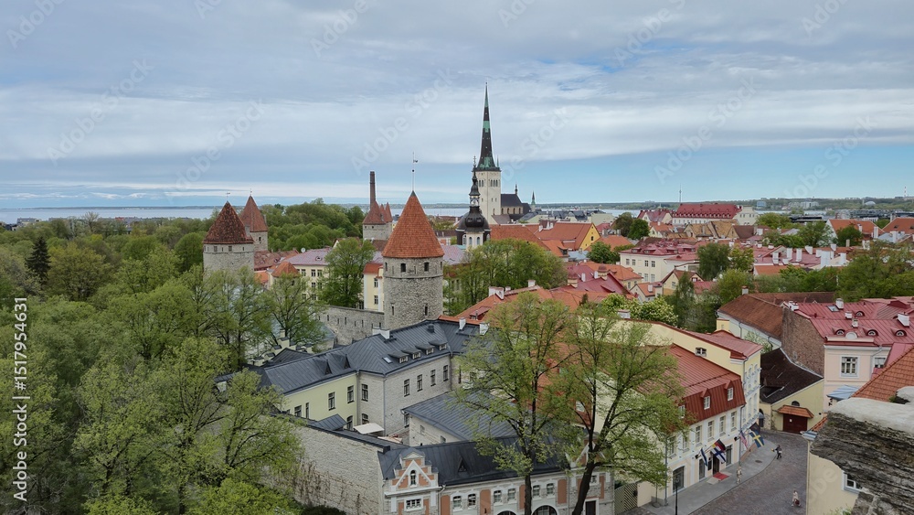 Picturesque view of Tallinn medieval city center with colorful rooftops, towers and the Baltic Sea in the background Picturesque view of Tallinn medieval city center with colorful rooftops, towers and the Baltic Sea in the background