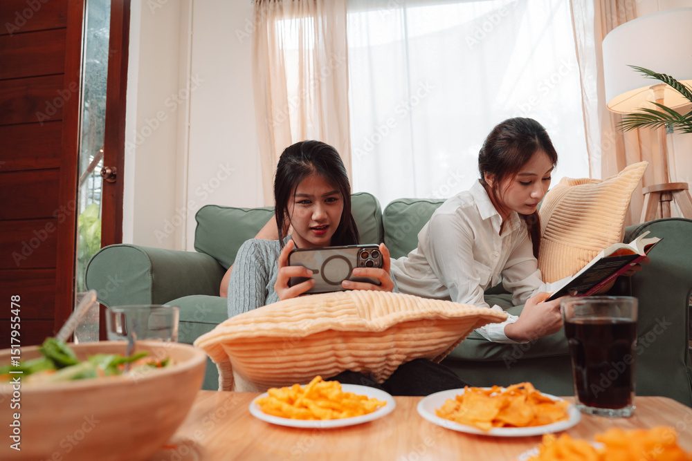 Asian Woman Friend Doing Lifestyle Indoor Smiling Phone Happiness, Sharing Joy and Memories Together at Home, Relaxing on Sofa with Smart Devices and Family Bonding Moments Asian Woman Friend Doing Lifestyle Indoor Smiling Phone Happiness, Sharing Joy and Memories Together at Home, Relaxing on Sofa with Smart Devices and Family Bonding Moments