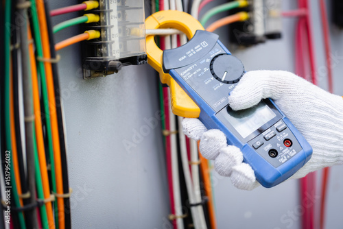 Ταπετσαρία Engineer is working on high voltage power substation using clamp meter for inspe