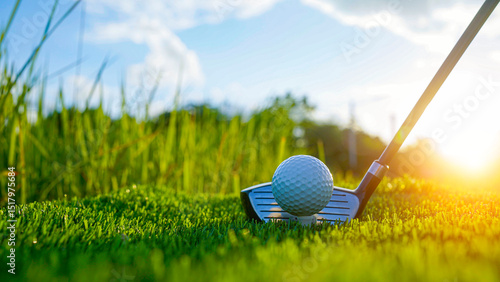 Golf clubs and golf balls on a green lawn in a beautiful golf course.