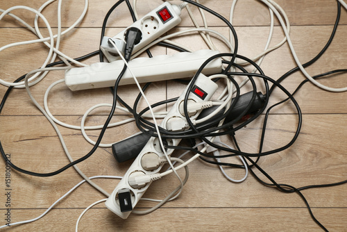Εκτύπωση καμβά Extension power boards overloaded with plugs on wooden floor, top view