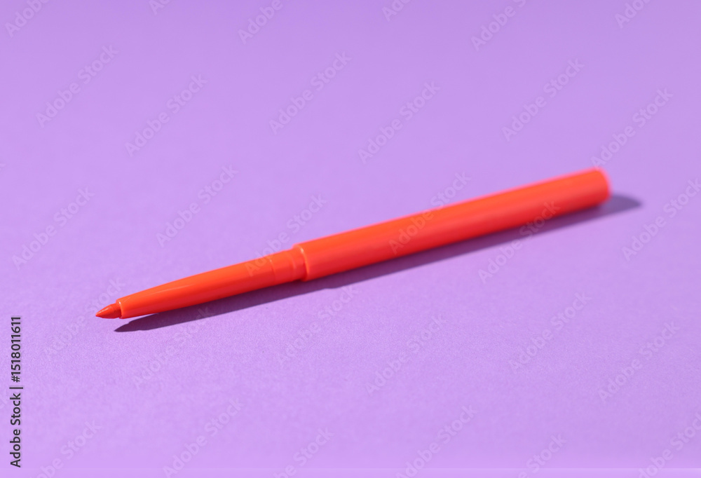 One twist up eye pencil on purple background, closeup One twist up eye pencil on purple background, closeup