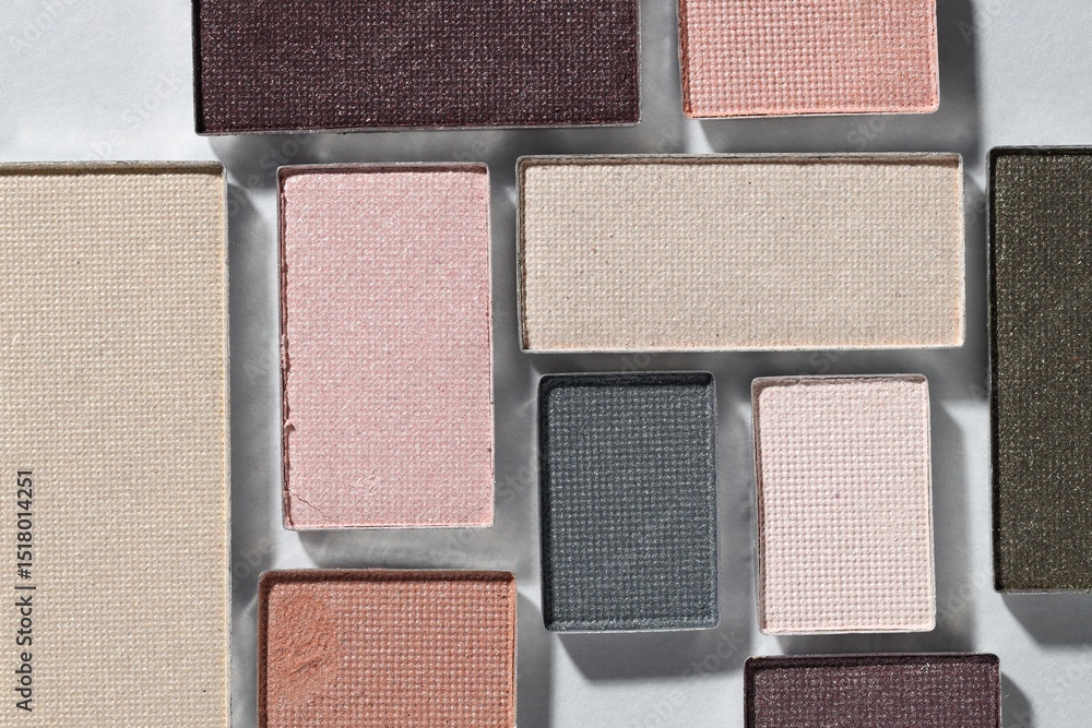Fototapeta premium Beautiful eyeshadow refill pans on light background, flat lay