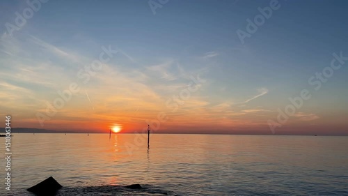 Peaceful morning at Barceloneta Beach with sunrise over the sea