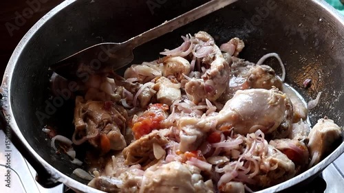 Delicious Irani Chicken Karahi (Kadai Bhuna) curry stirred with spatula in home kitchen. Close-up of hot, spicy Iranian chicken kadhai cooking, savory and appetizing.