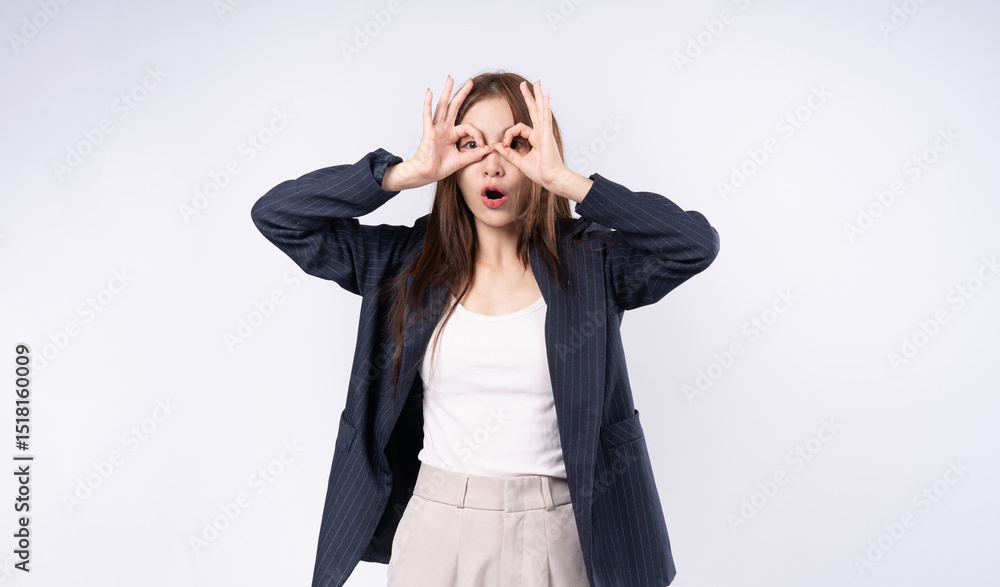 Portrait of woman in suit making symbolic gesture, glasses over eyes, shocked expression, studio shot on white background. Portrait of woman in suit making symbolic gesture, glasses over eyes, shocked expression, studio shot on white background.