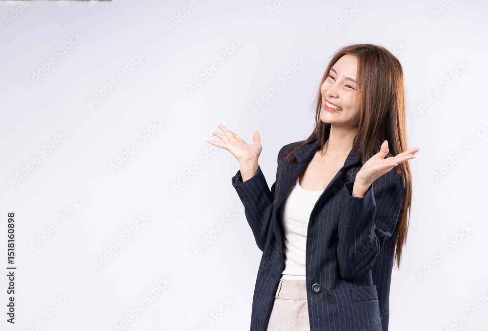 Beautiful Asian woman in suit raising both hands showing product presentation with confidence and friendly smile. Beautiful Asian woman in suit raising both hands showing product presentation with confidence and friendly smile.