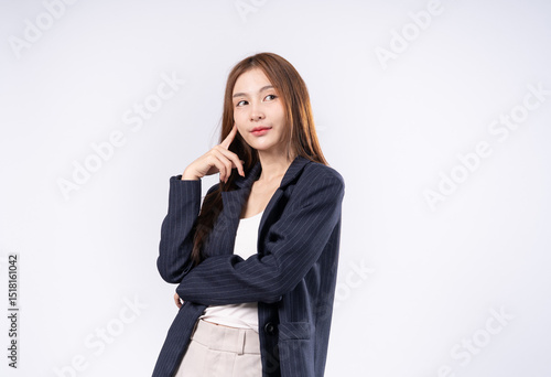 Beautiful Asian woman with brown hair in suit posing thinking portrait in studio on white background