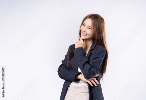 Beautiful Asian woman with brown hair in suit posing thinking portrait in studio on white background
