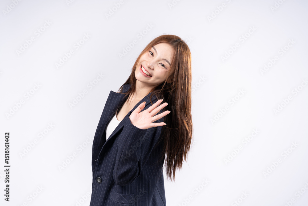 Beautiful Asian woman with brown hair in suit waving gesture saying hello smiling face portrait in studio white background Beautiful Asian woman with brown hair in suit waving gesture saying hello smiling face portrait in studio white background