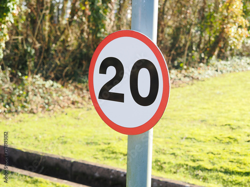 close up of a UK maximum road speed limit sign showing 20 mph as the top speed