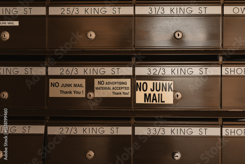 No junk mail signs on apartment building letter boxes
