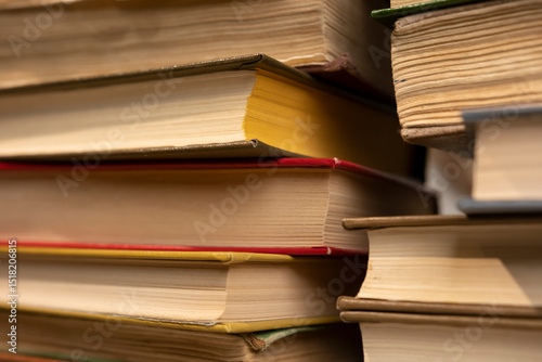 Books stacked together on a table in a cozy reading nook during the afternoon