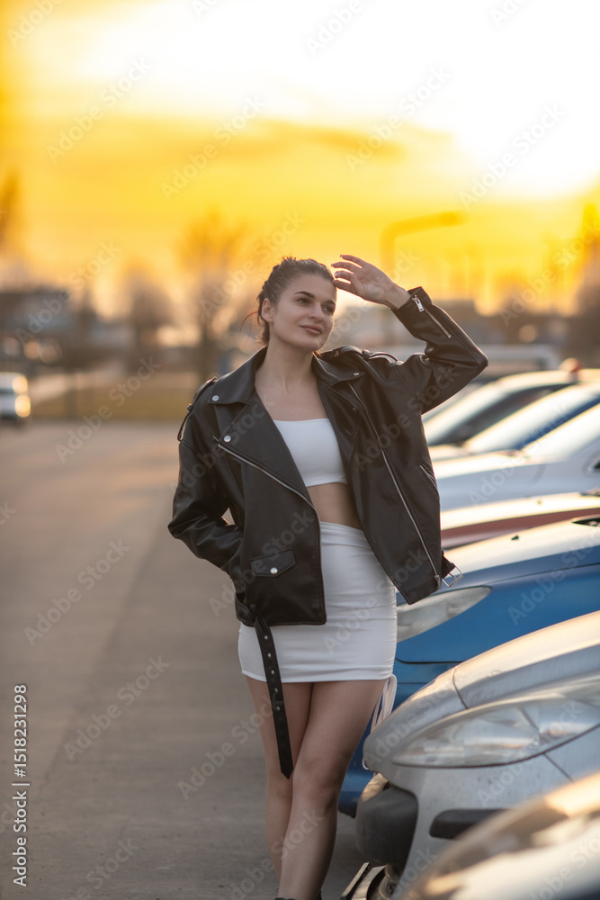 Portrait of a young beautiful dark-haired girl in a black jacket in an urban environment. Portrait of a young beautiful dark-haired girl in a black jacket in an urban environment.