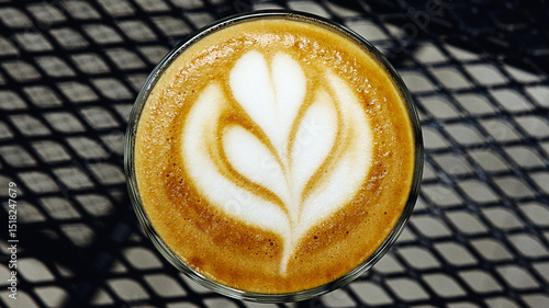 Tulip Latte Art in Glass Cup on Black Metal Table