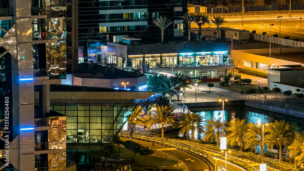 Buildings of Jumeirah Lakes Towers with traffic on the road night timelapse. Buildings of Jumeirah Lakes Towers with traffic on the road night timelapse.