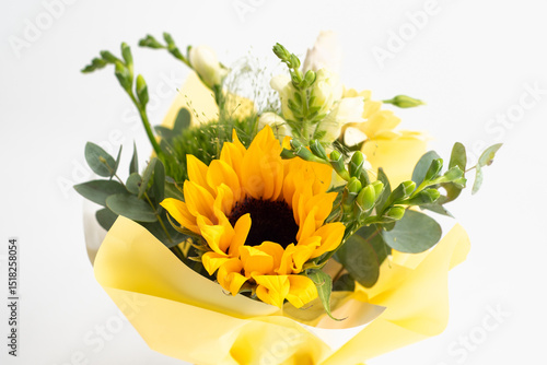 Foto Bright Sunflower Bouquet in Yellow Wrapping on White Isolated Background
