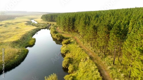 Aerial View of Serpentine River Meandering Through Lush Grassland and