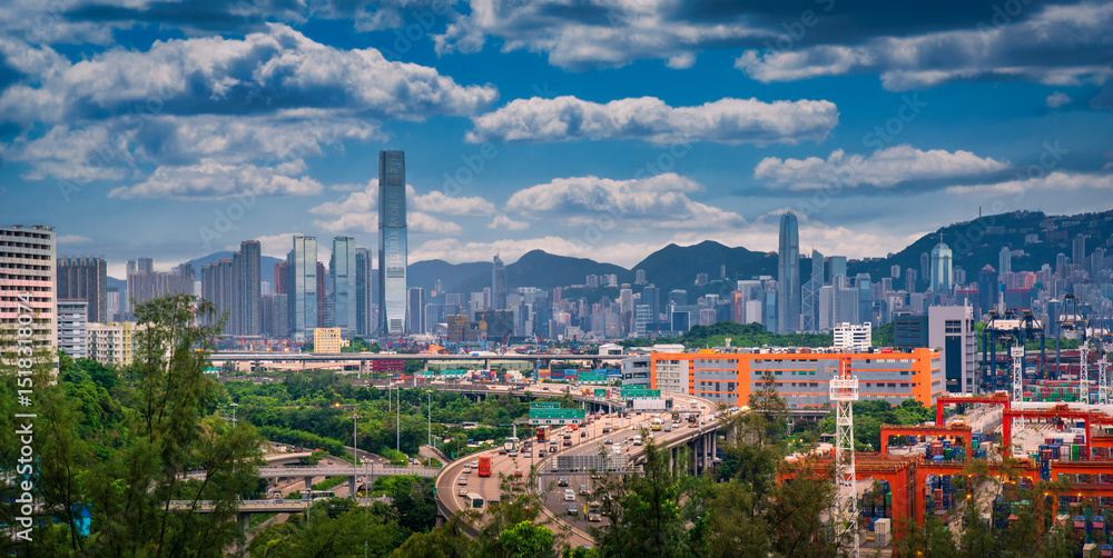 Obraz premium Hong Kong city on dramatic sky at sunset view from mountain.