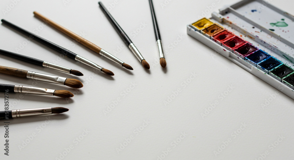 Obraz premium watercolor paints and brushes on white